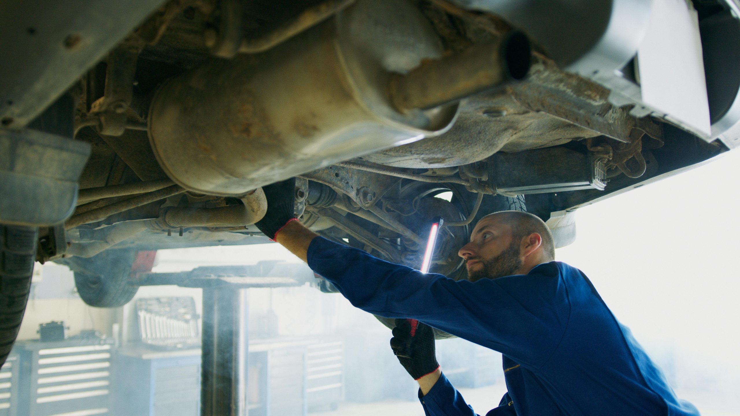 mechanic under a vehicle